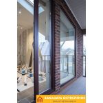 Коричневые портальные двери в зимний сад с панорамным остеклением